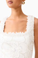 Brunette model wearing the Elowen Floral Applique Midi Dress in White details shot 