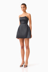 Brunette model wearing the Manon Tulip Mini Dress in black side shot