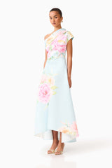 Brunette model wearing the Harper Asymmetrical Gown in Baby Blue Floral side shot 