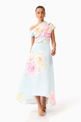 Brunette model wearing the Harper Asymmetrical Gown in Baby Blue Floral posed walking shot 