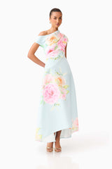 Brunette model wearing the Harper Asymmetrical Gown in Baby Blue Floral posed shot 