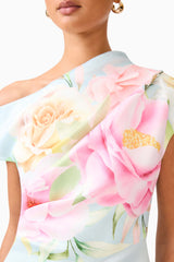 Brunette model wearing the Harper Asymmetrical Gown in Baby Blue Floral detail shot 