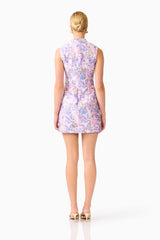 Blonde model wearing the Marlene Shift Mini Dress in Pink & Lilac Floral back shot
