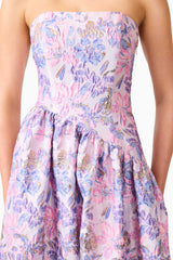 Blonde model wearing the Marlene Asymmetrical Gown in Pink & Purple Floral detail shot