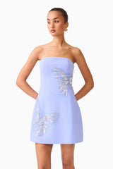 Brunette model wearing the Mira Strapless Mini Dress in Blue close up shot 