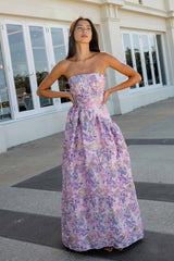 Blonde model wearing the Marlene Asymmetrical Gown in Pink & Purple Floral front shot influencer shot