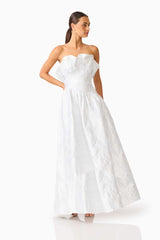 Brunette model wearing the Laurel Sleeveless Maxi Dress in Silver posed looking away shot