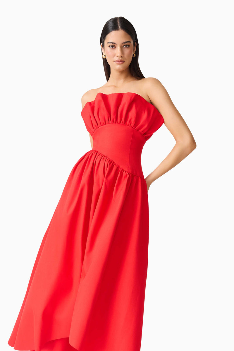 Brunette model wearing LAUREL SLEEVELESS MAXI DRESS IN RED close up posed dress