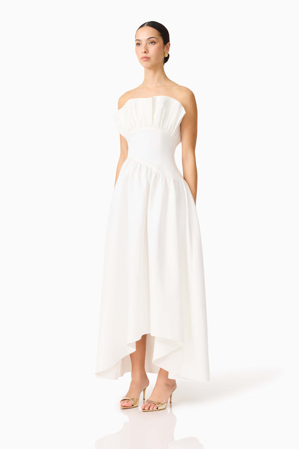 Brunette model wearing the Laurel Sleeveless Maxi Dress In White side shot 