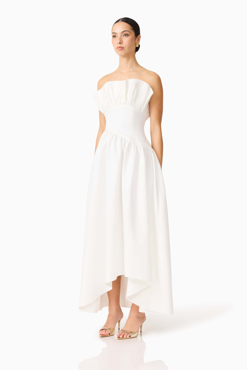 Brunette model wearing the Laurel Sleeveless Maxi Dress In White side shot 