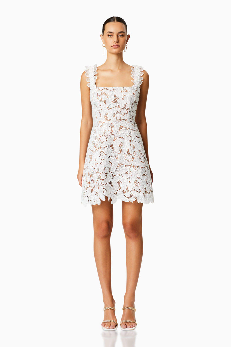 Brunette model wearing PINE LACE MINI DRESS in WHITE front shot