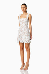 Brunette model wearing PINE LACE MINI DRESS in WHITE side shot