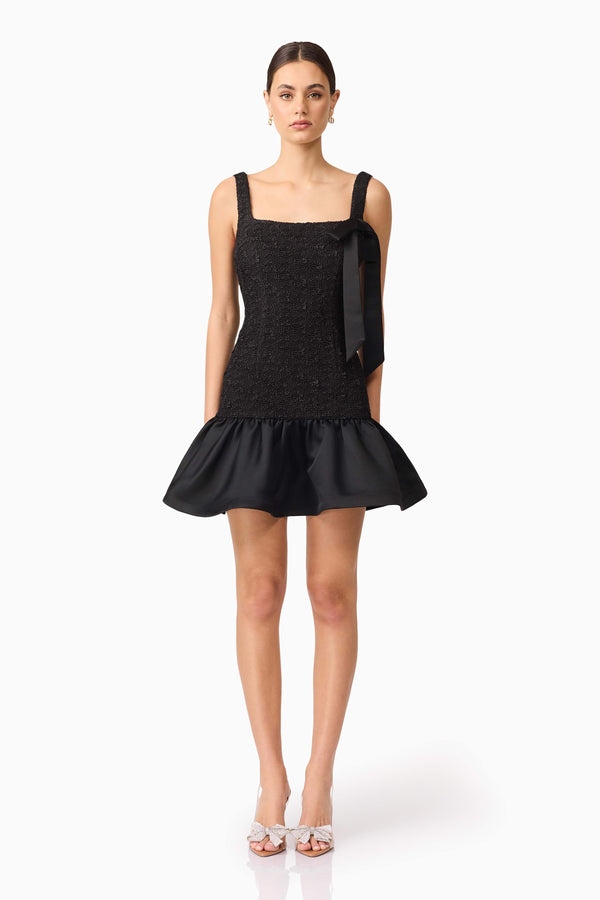 Brunette model wearing Dandelion Mini Dress in Black front shot