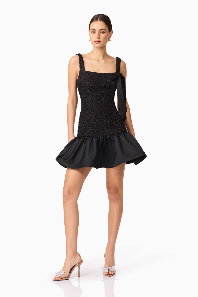Brunette model wearing Dandelion Mini Dress in Black posed shot