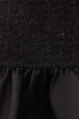 Brunette model wearing Dandelion Mini Dress in Black detail shot