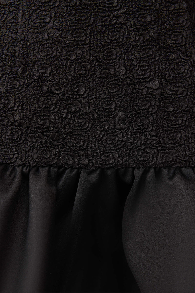Brunette model wearing Dandelion Mini Dress in Black detail shot