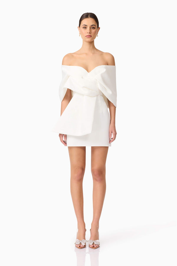 Brunette model wearing Dandelion Off The Shoulder Mini Dress in White front shot