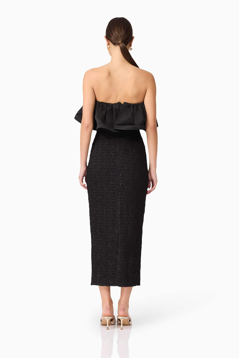 Brunette model wearing Dandelion Strapless Midi Dress in Black back shot