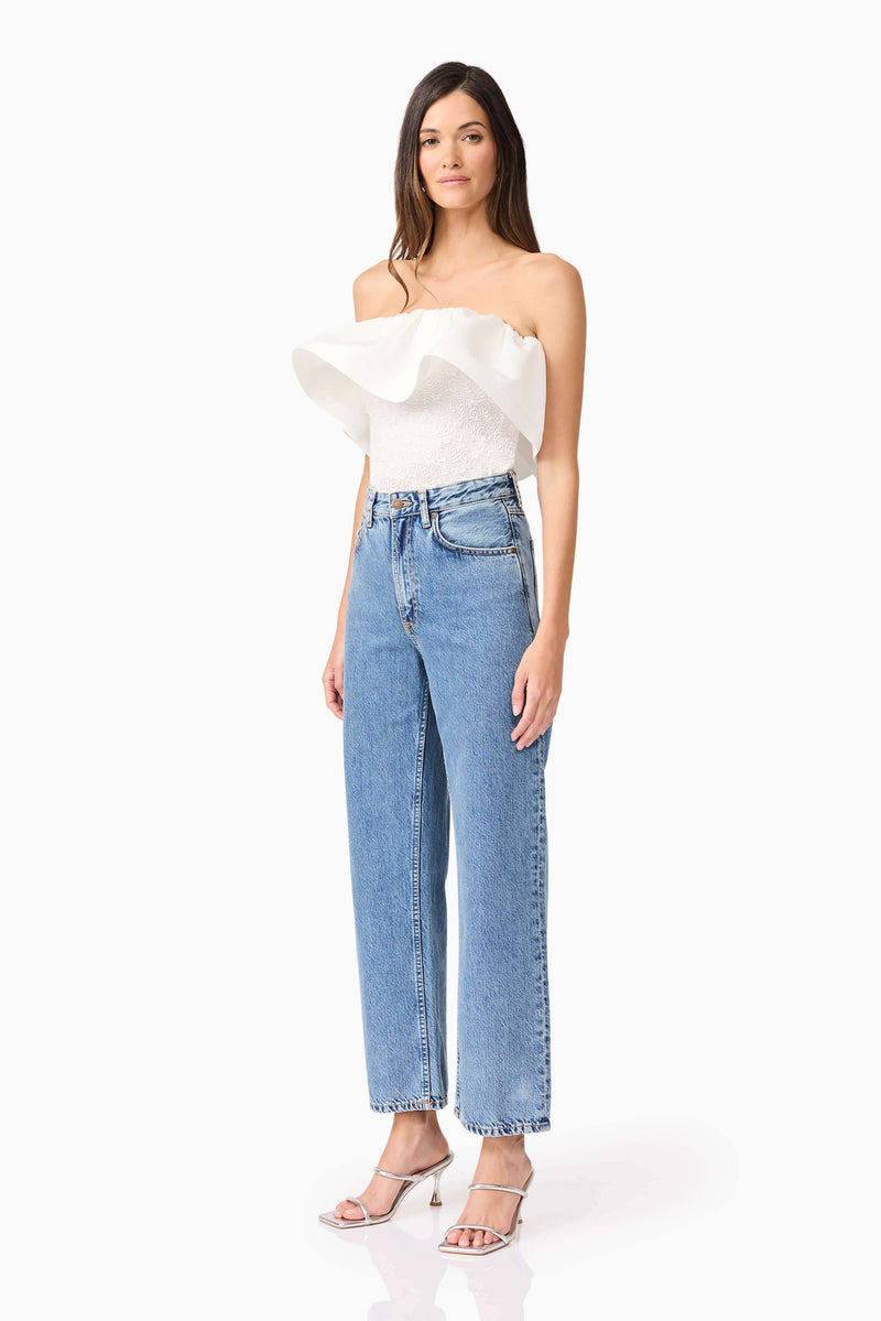 Brunette model wearing Dandelione Strapless Top in White side shot