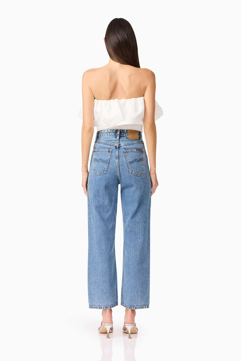 Brunette model wearing Dandelione Strapless Top in White back shot