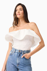 Brunette model wearing Dandelione Strapless Top in White close up posed shot