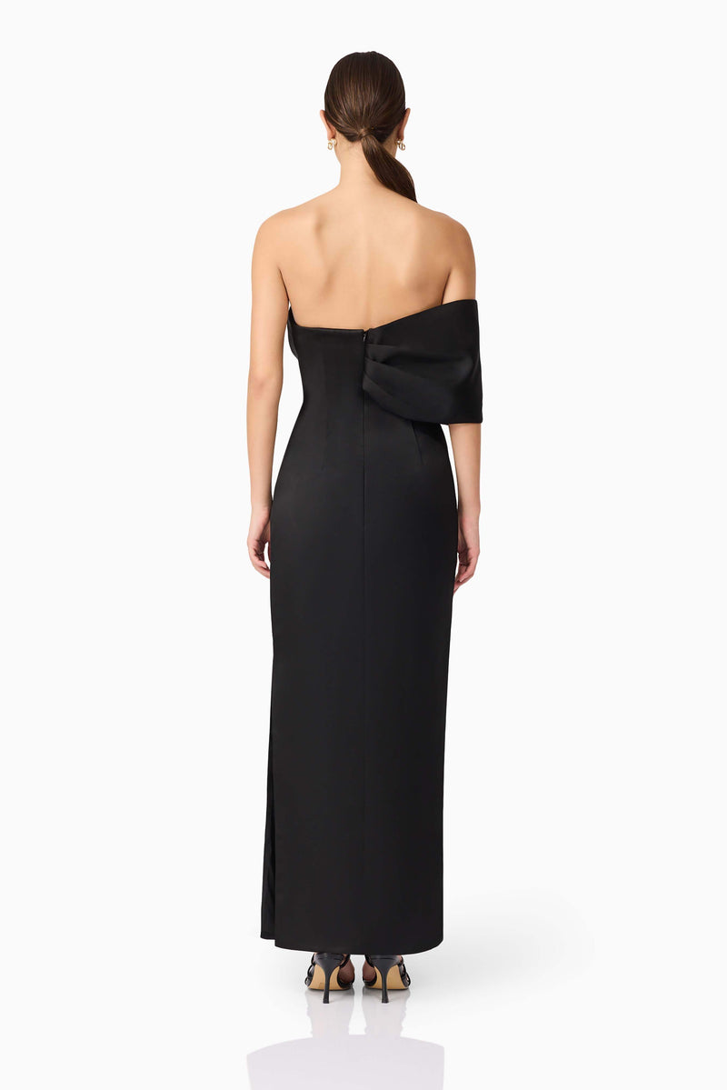 Brunette model wearing Dandelione Strapless Gown in Black back shot