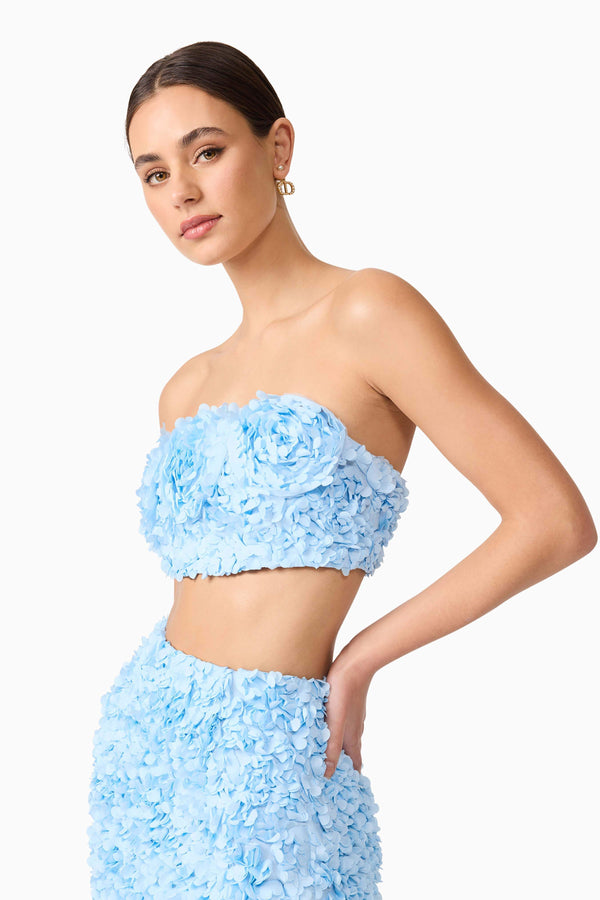 Brunette model wearing Kaia Rosette Set in Blue close up shot