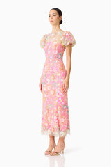 Brunette model wearing the Nathalie Puff Sleeve Gown in Pink Floral side shot 