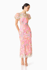 Brunette model wearing the Nathalie Puff Sleeve Gown in Pink Floral posed shot 