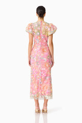 Brunette model wearing the Nathalie Puff Sleeve Gown in Pink Floral back shot 