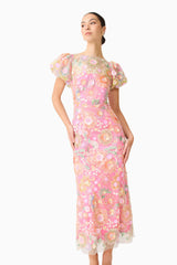 Brunette model wearing the Nathalie Puff Sleeve Gown in Pink Floral close up looking away shot 