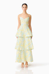 Brunette model wearing the Penelope Tiered Gown in Yellow & Blue Floral front shot 