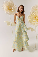 Brunette model wearing the Penelope Tiered Gown in Yellow & Blue Floral campaign shot 