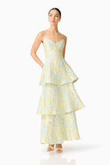 Brunette model wearing the Penelope Tiered Gown in Yellow & Blue Floral posed shot 