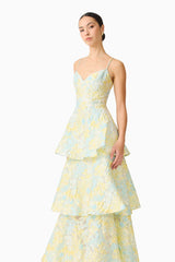 Brunette model wearing the Penelope Tiered Gown in Yellow & Blue Floral close up shot 