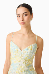 Brunette model wearing the Penelope Tiered Gown in Yellow & Blue Floral detail shot 