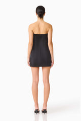 Brunette model wearing the Sydney Strapless Mini Dress in Black back shot 