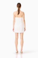 Brunette model wearing the Sydney Strapless Mini Dress in White back shot 