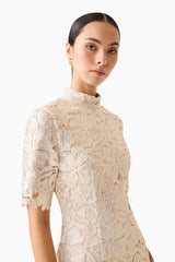 Brunette model wearing the Nicoletta Short Sleeve Mini Dress in Gold detail shot