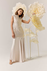 Brunette model wearing the Nicoletta High Neck Gown in Gold campaign shot