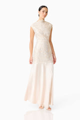 Brunette model wearing the Nicoletta High Neck Gown in Gold posed shot