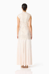 Brunette model wearing the Nicoletta High Neck Gown in Gold back shot