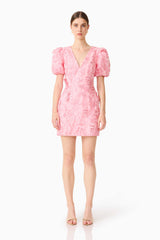 Brunette model wears the Monique Puff Sleeve Mini Dress in Pink, straight shot