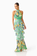 Brunette model wearing the Gardenia Halter Maxi Gown In Green side posed shot