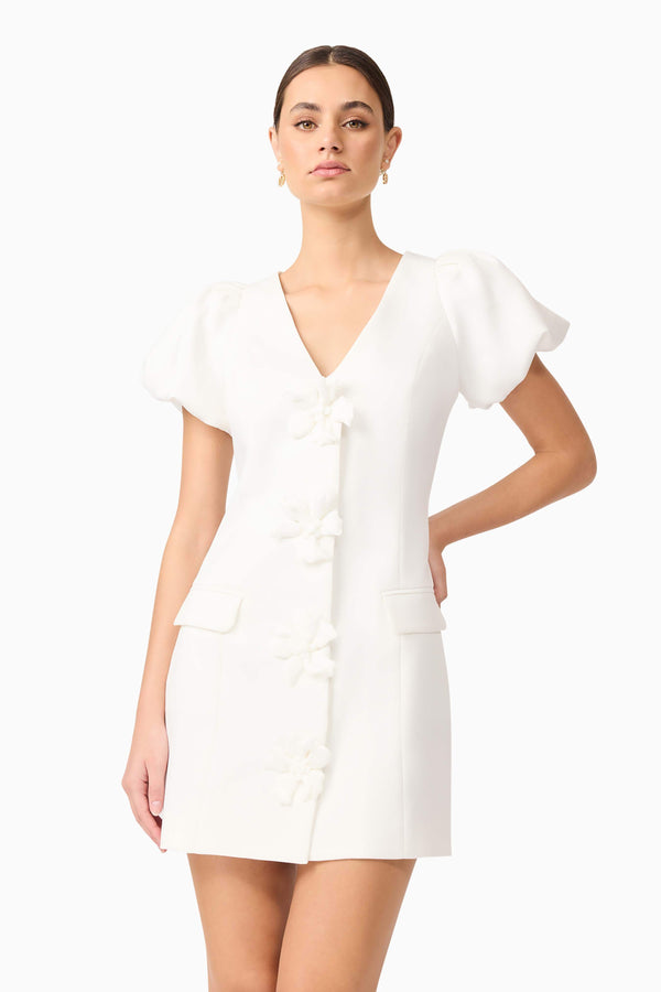 Brunette model wears Elysie Blazer Mini Dress in White front close up