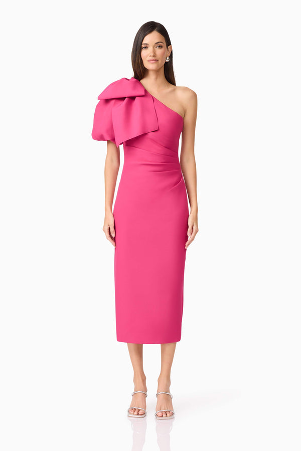 Brunette model wears Elysie Midi Dress in Pink front view