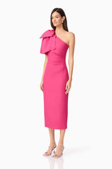 Brunette model wears Elysie Midi Dress in Pink side view