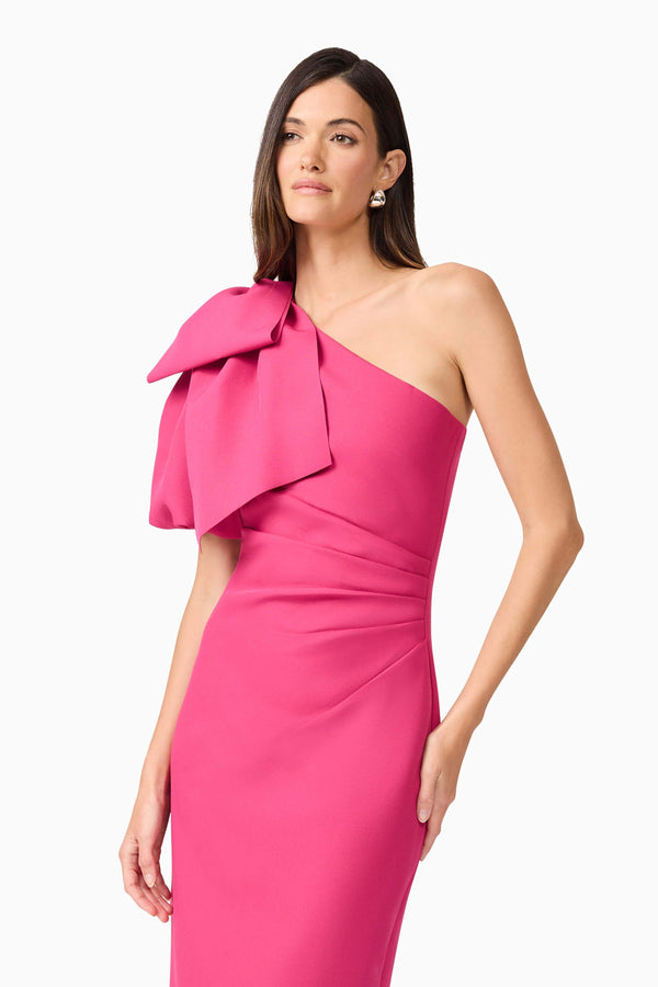 Brunette model wears Elysie Midi Dress in Pink front view front close up