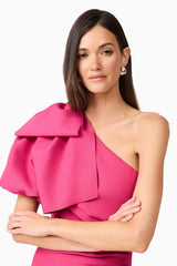 Brunette model wears Elysie Midi Dress in Pink front view arms crossed close up