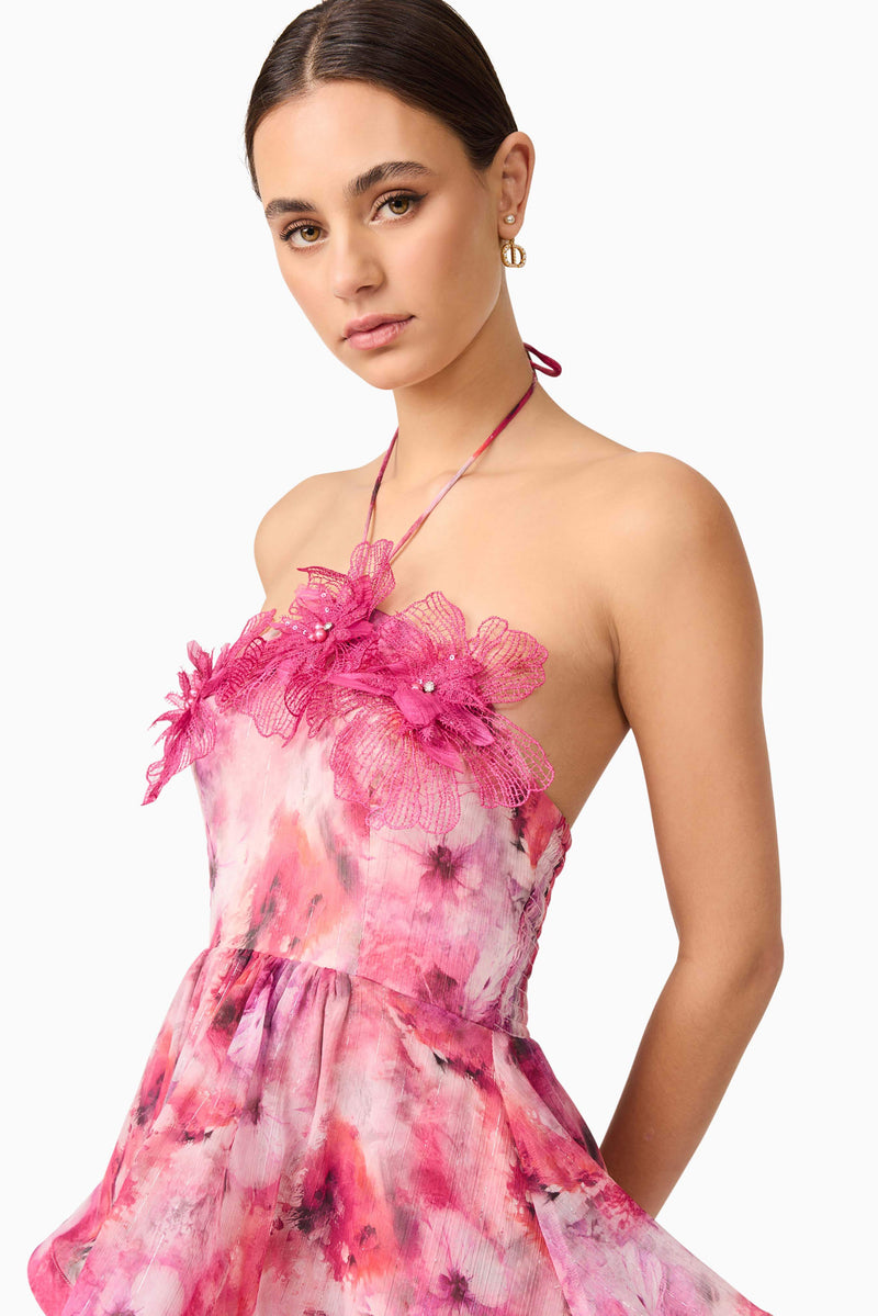 Brunette model wearing Evalina Floral Mini Dress in Pink close up posed shot